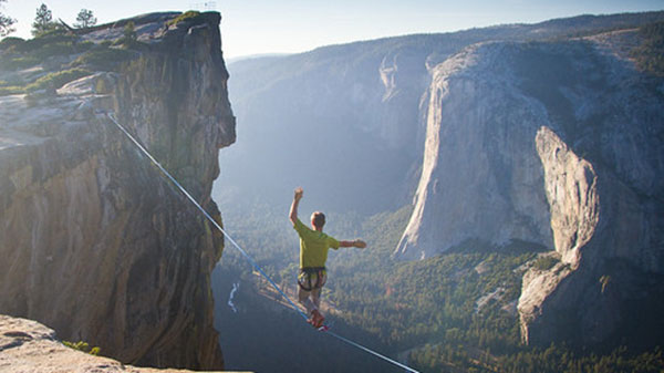 Person walking on tightrope with no safety net